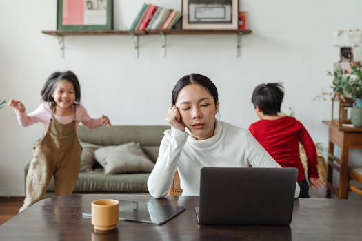 image of a stressed working mother balancing work and family responsibilities