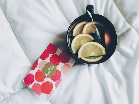 self-care essentials like tea and a cozy blanket