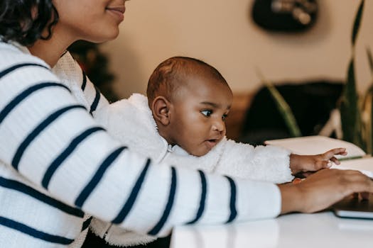 working mother smiling at her desk